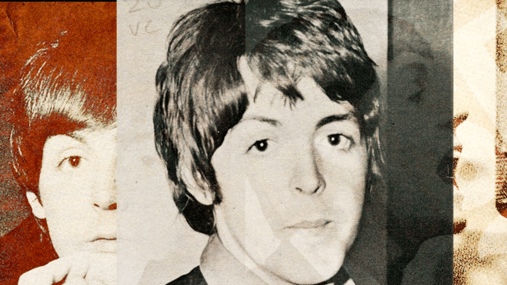Paul McCartney jouant la guitare sur scène